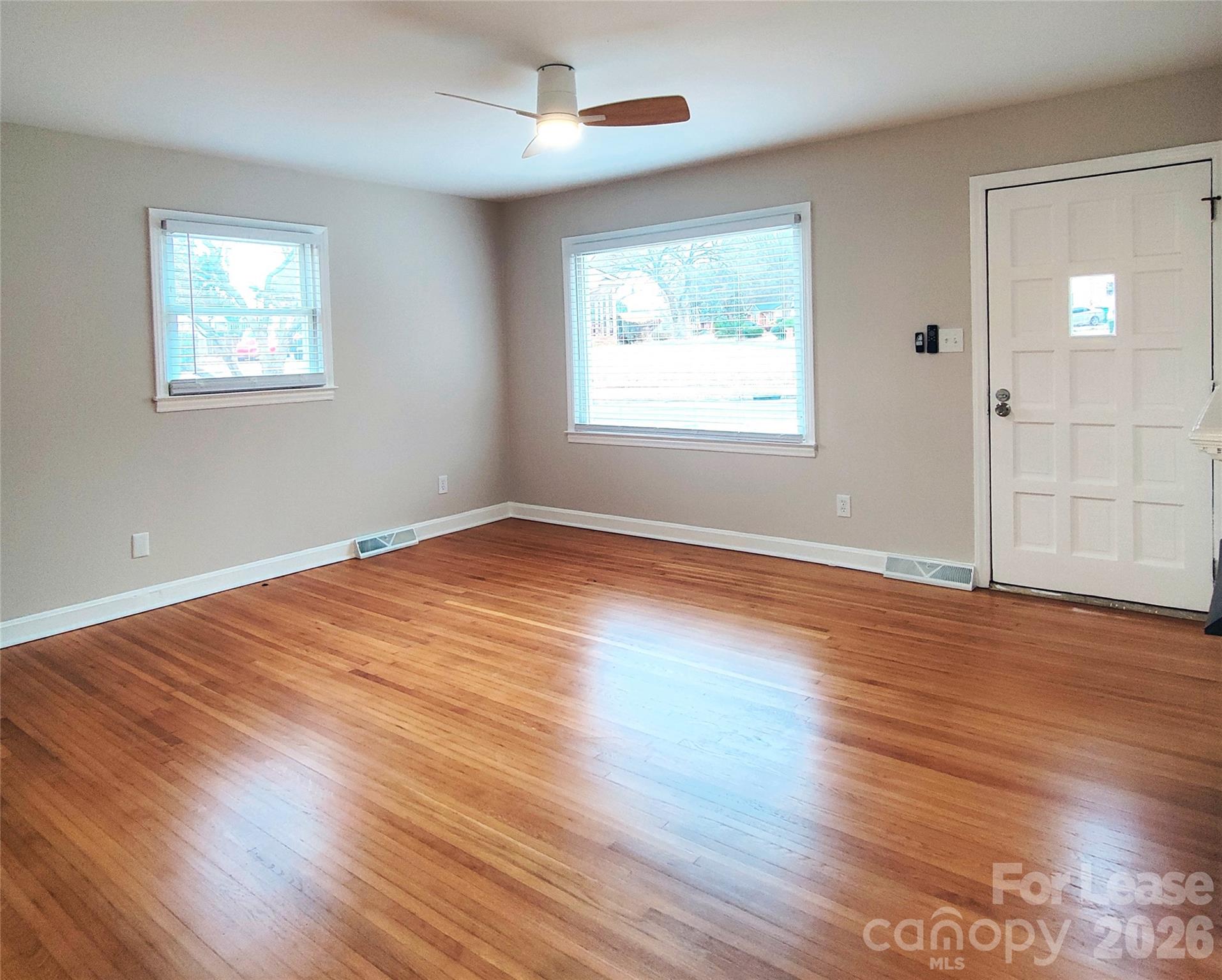 4100 Broadview Drive Charlotte, NC 28217 - Photo 11 of 24 a view of an empty room with wooden floor and a window