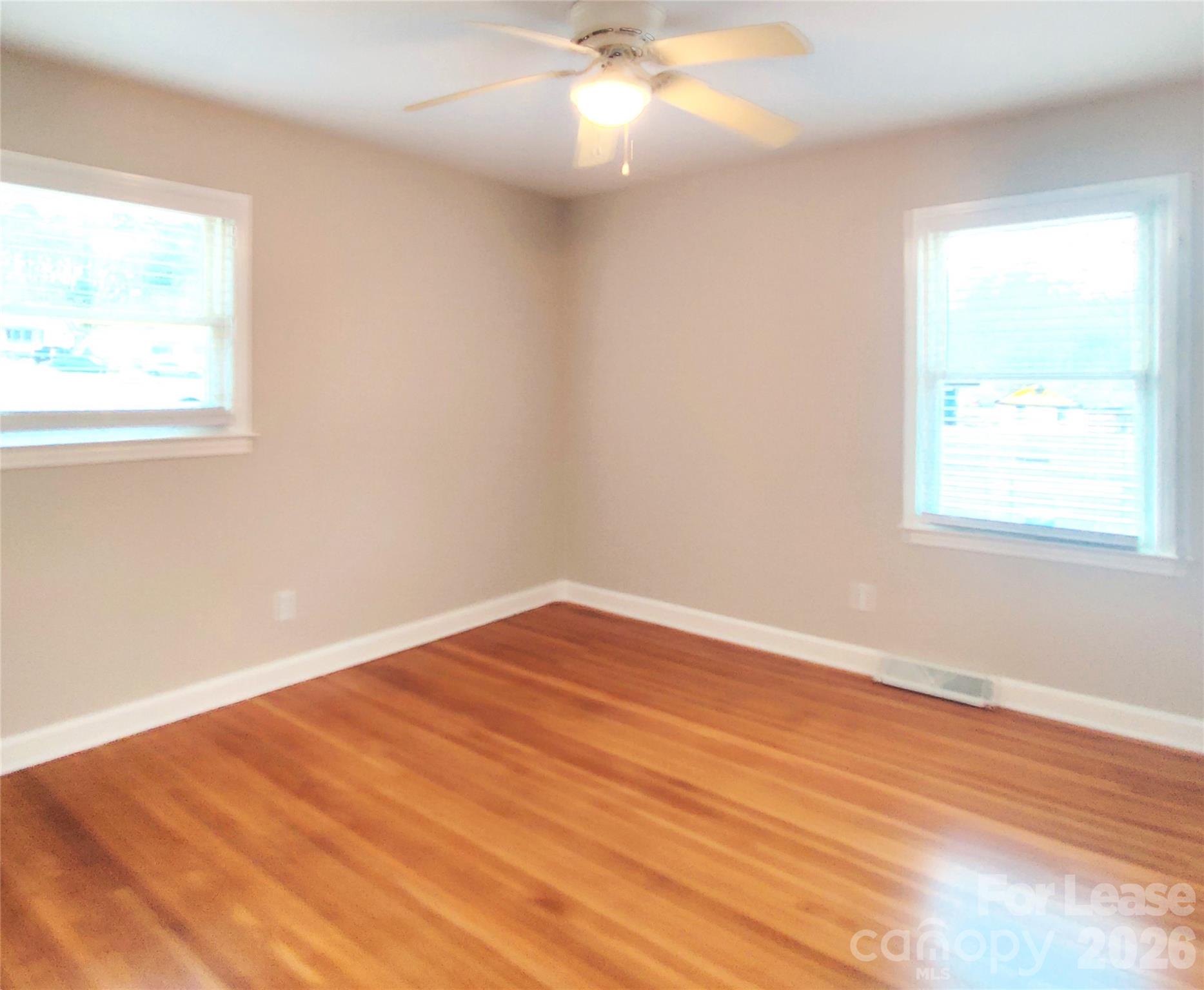4100 Broadview Drive Charlotte, NC 28217 - Photo 13 of 24 an empty room with wooden floor and windows