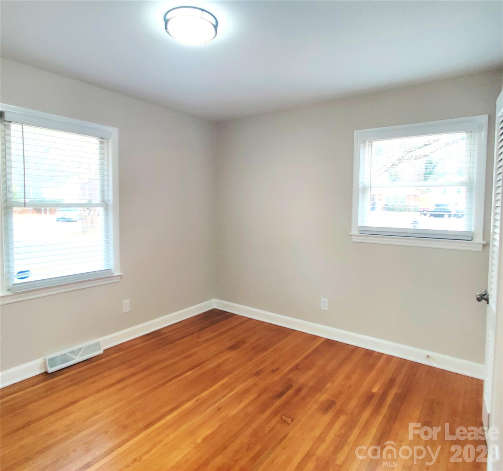 4100 Broadview Drive Charlotte, NC 28217 - Photo 15 of 24 an empty room with wooden floor and windows