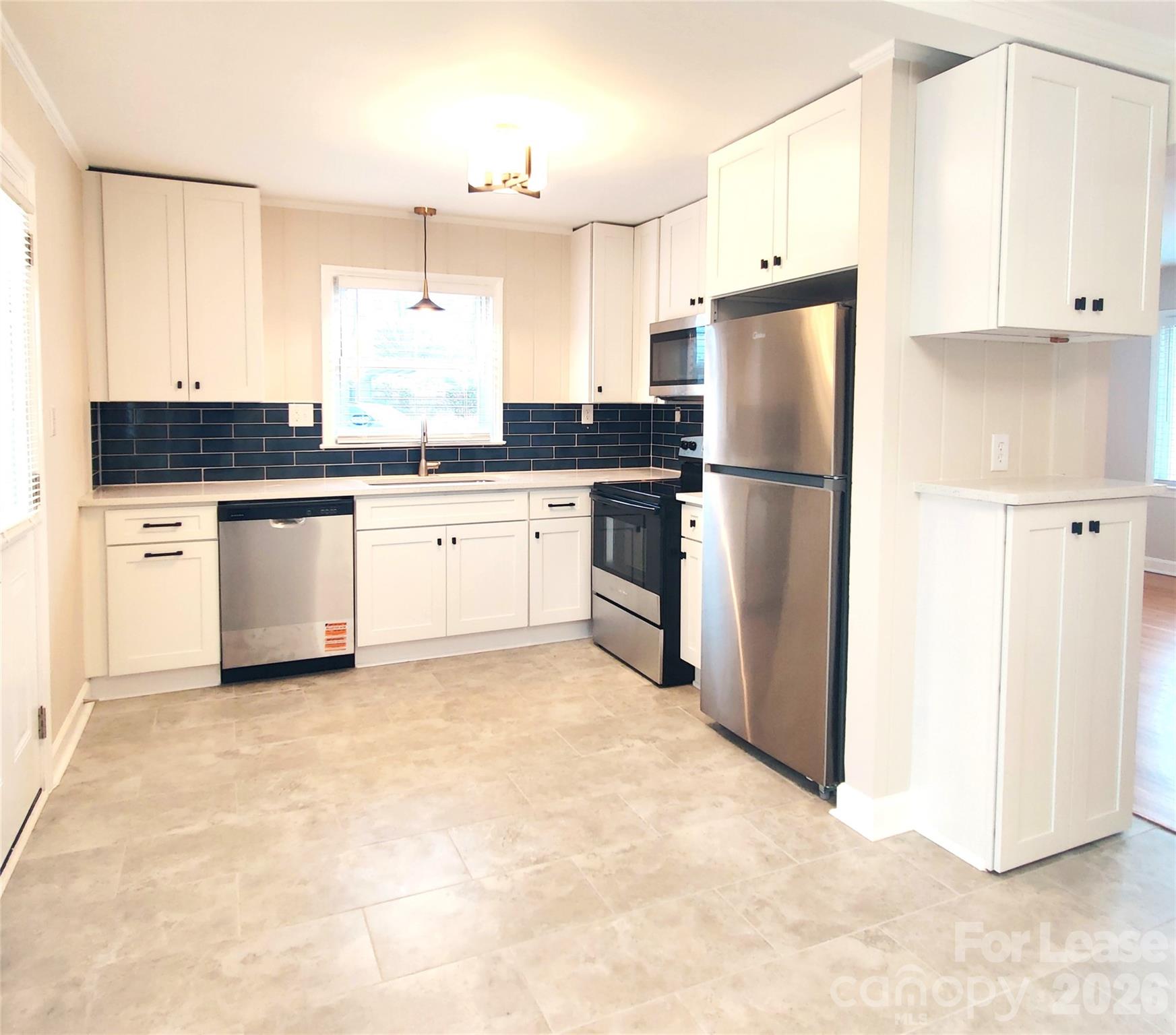 4100 Broadview Drive Charlotte, NC 28217 - Photo 2 of 24 a kitchen with a refrigerator sink and cabinets