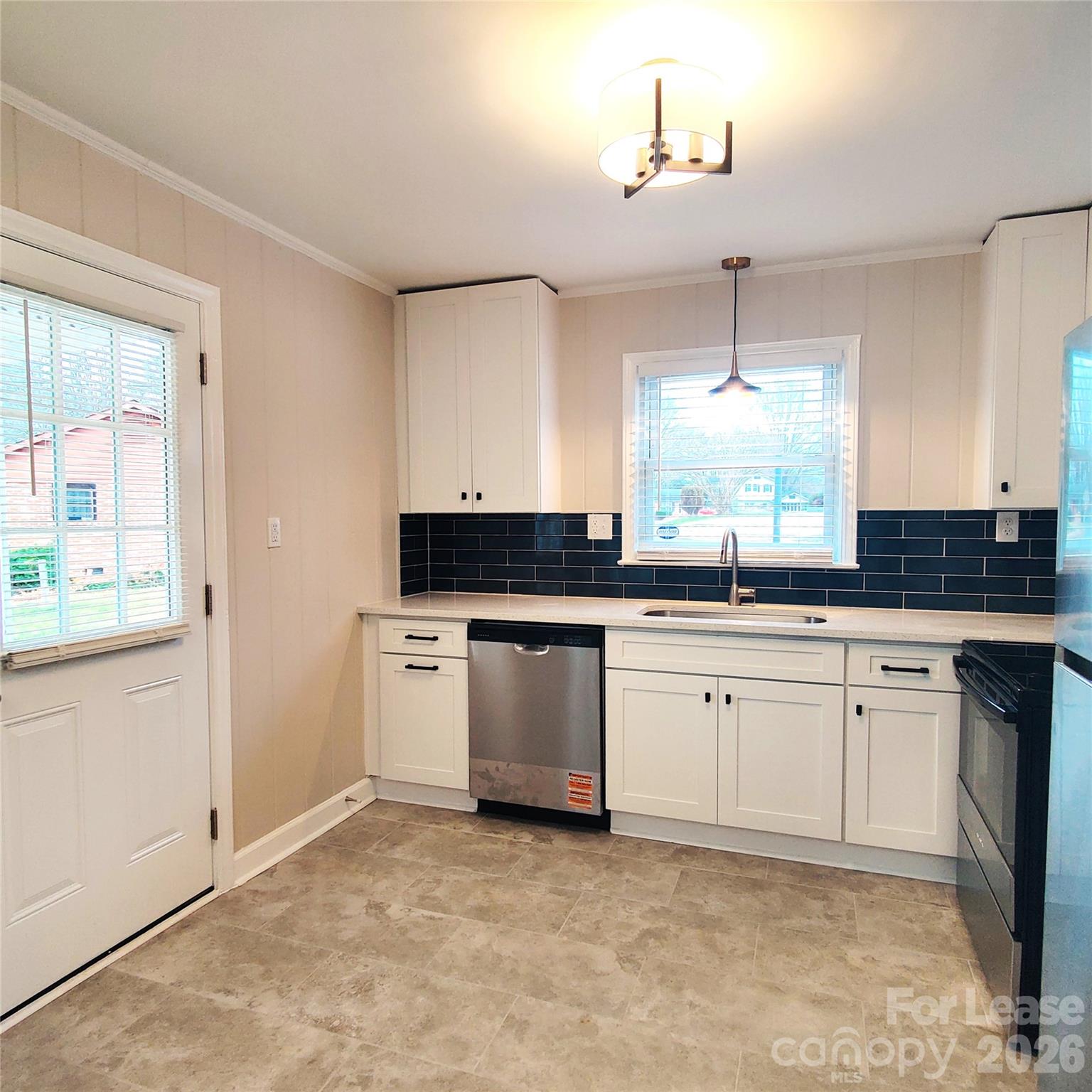 4100 Broadview Drive Charlotte, NC 28217 - Photo 4 of 24 a kitchen with stainless steel appliances granite countertop a stove a sink and a refrigerator