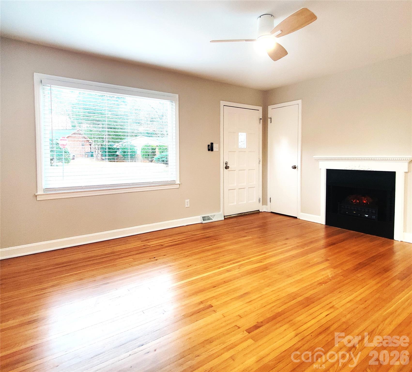 4100 Broadview Drive Charlotte, NC 28217 - Photo 8 of 24 a view of an empty room with wooden floor and a window