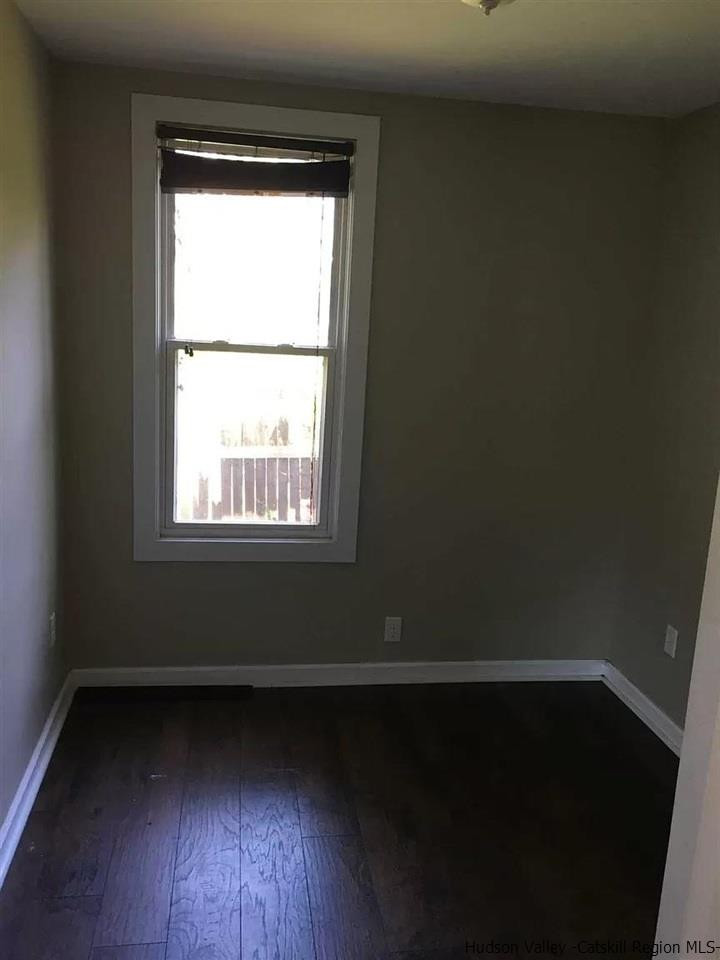 39 Spruce Street Poughkeepsie, NY 12601 - Photo 2 of 20 a view of an empty room with wooden floor and a window