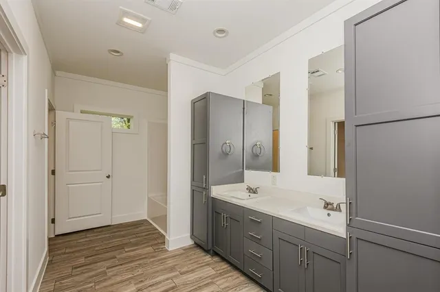 a bathroom with a double vanity sink mirror and shower