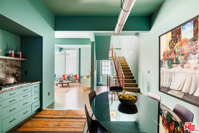 a dining room with furniture and wooden floor