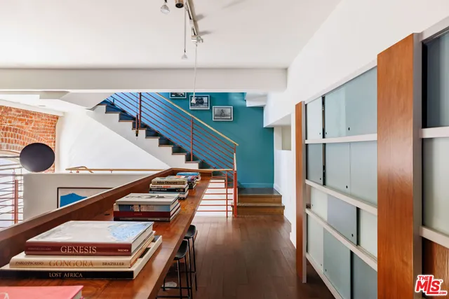 a view of a chairs and table on the terrace with a barbeque