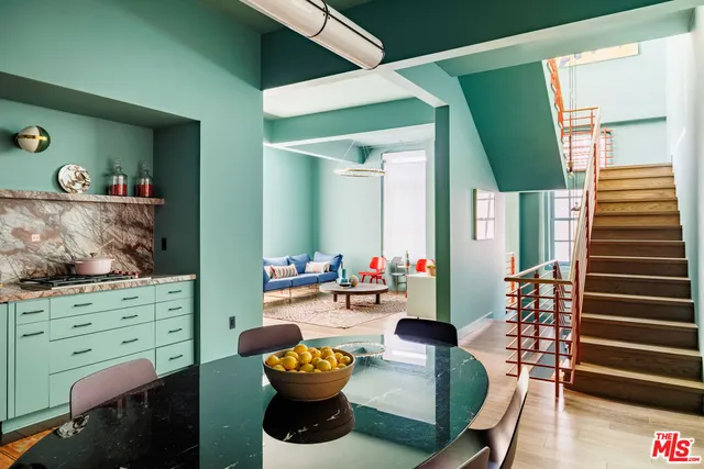 a dining room with furniture and wooden floor