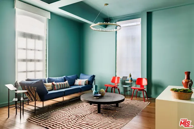 a living room with furniture and a potted plant