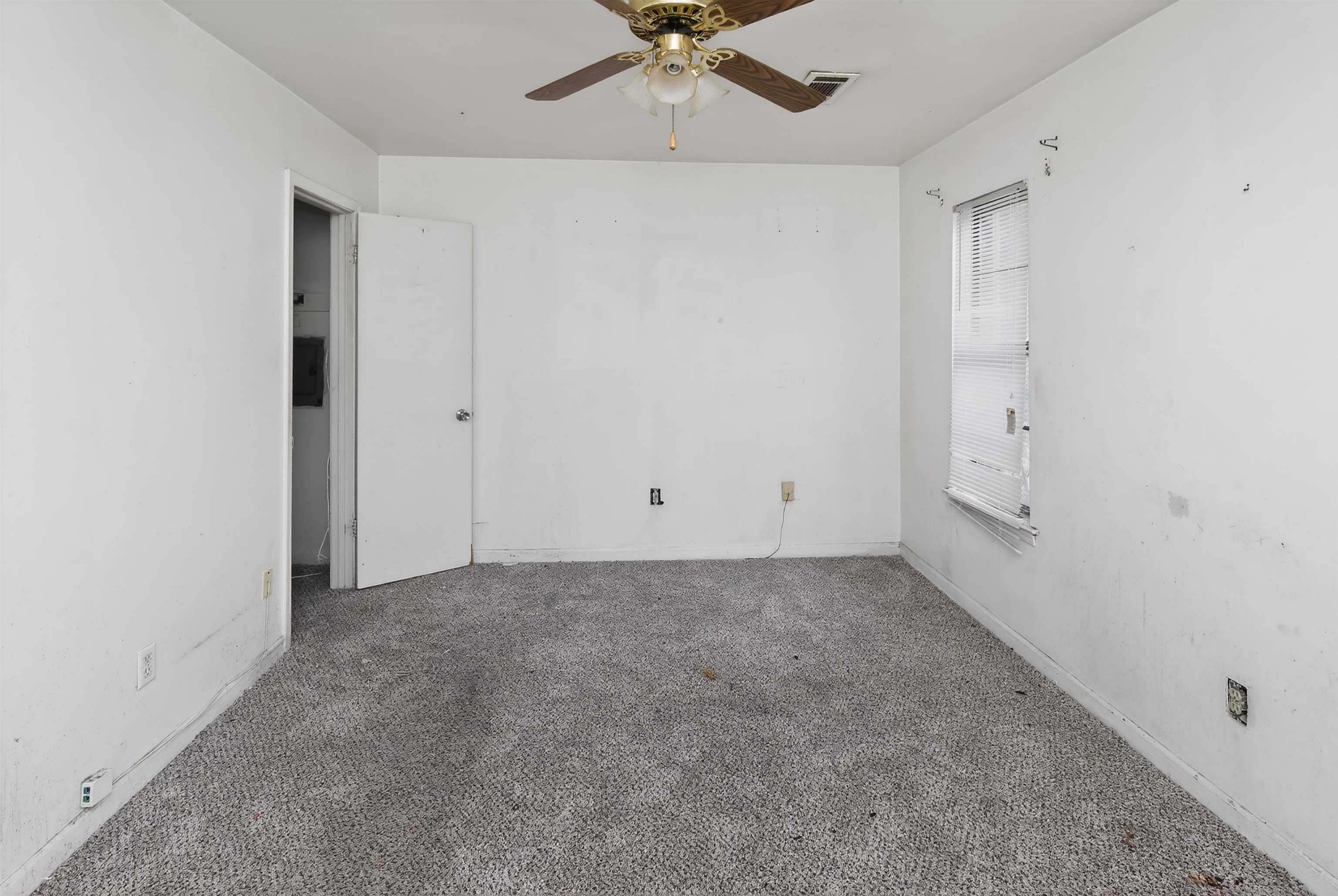 3451 Birdsong Ferry Road Memphis, TN 38118 - Photo 17 of 27 White-painted interior room featuring a ceiling fan, a single window with blinds, and gray carpet flooring