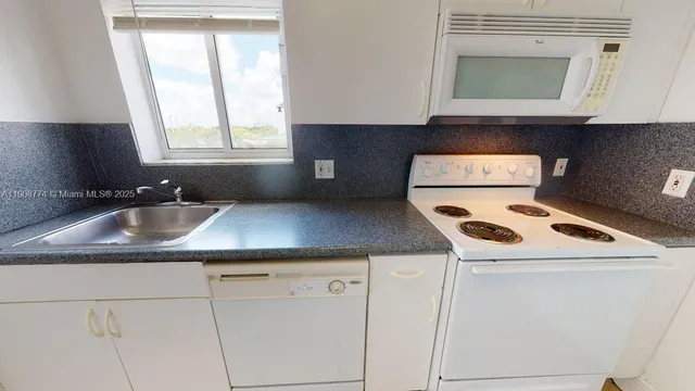 a kitchen with a sink stove and cabinets
