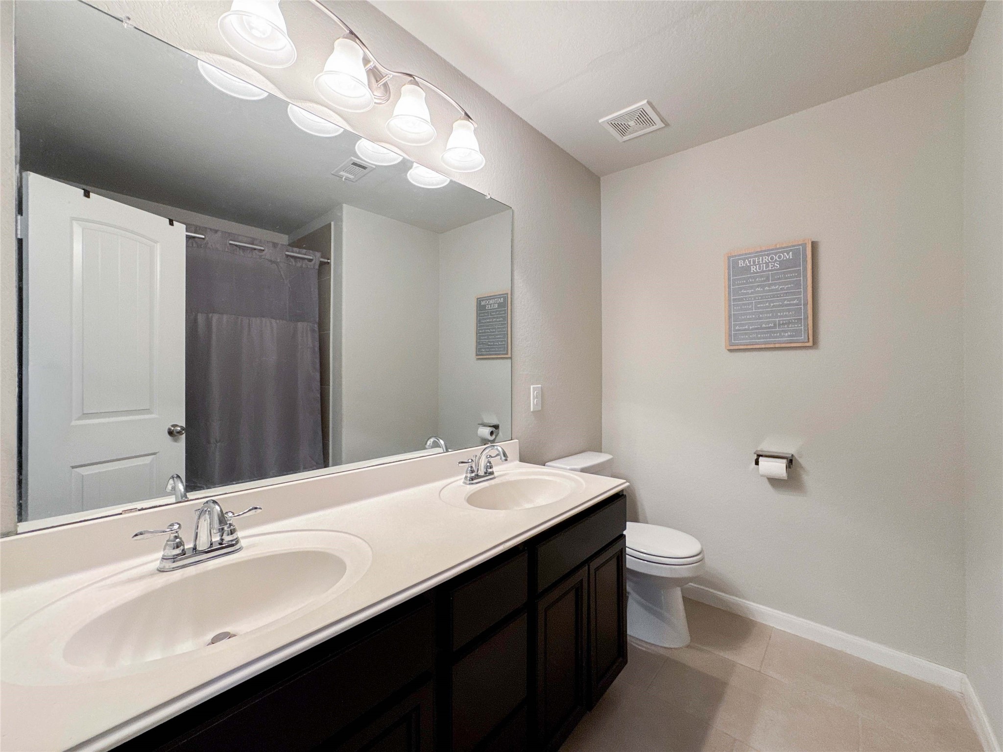 2 Eagle Lake Court Manvel, TX 77578 - Photo 25 of 38 a bathroom with a double vanity sink toilet and a mirror