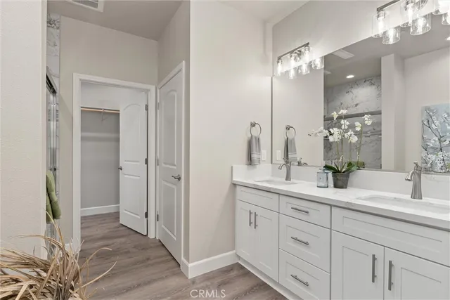 a bathroom with a double vanity sink and a mirror