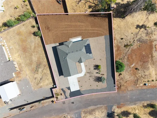 an aerial view of a house with a backyard