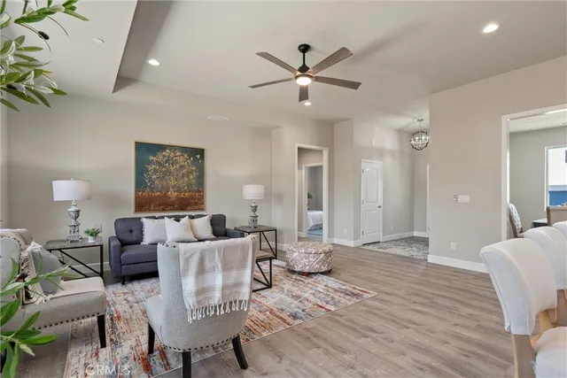 a living room with furniture and a ceiling fan