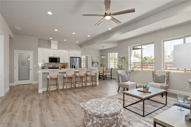 a living room with lots of furniture and view of kitchen