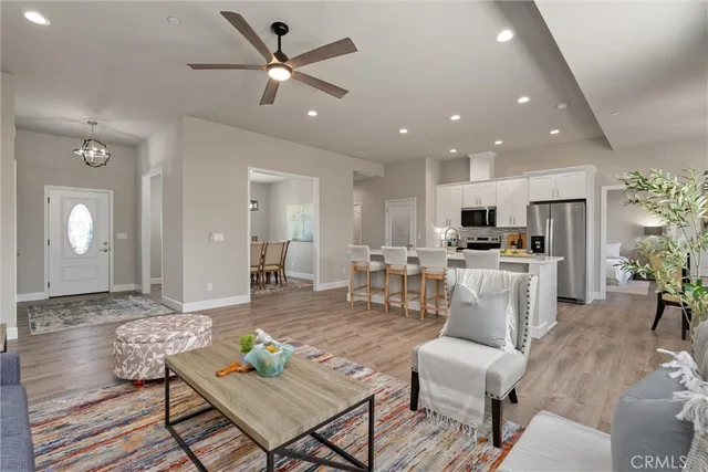 a living room with furniture and kitchen view