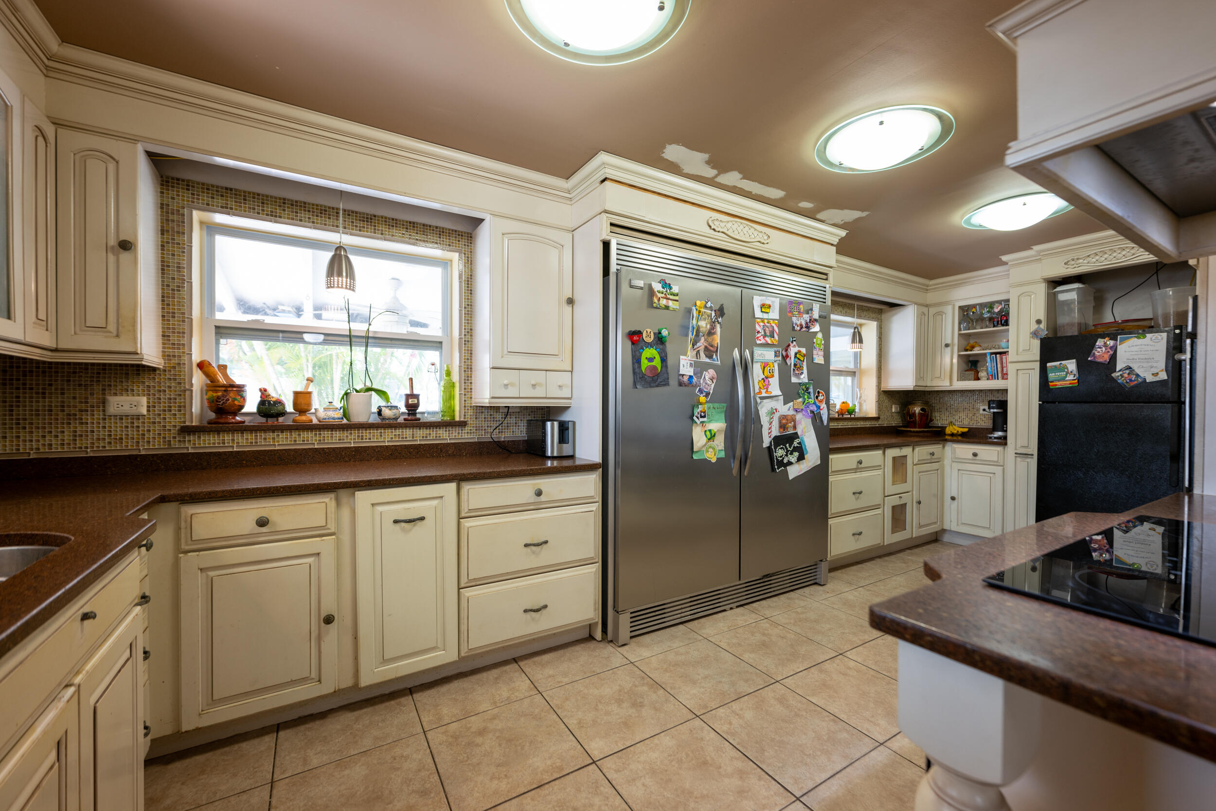 1229 5th Street Key West, FL 33040 - Photo 8 of 40 a kitchen with stainless steel appliances granite countertop a refrigerator and a sink