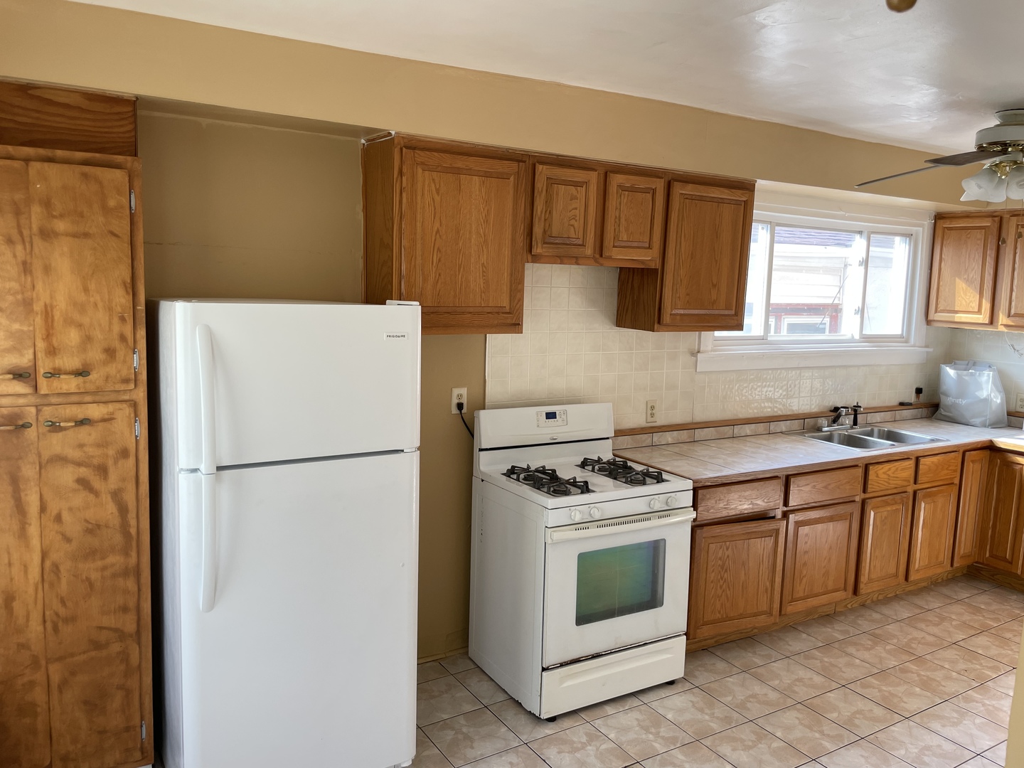 9309 South Ada Street Chicago, IL 60620 - Photo 14 of 39 a white refrigerator freezer sitting inside of a kitchen