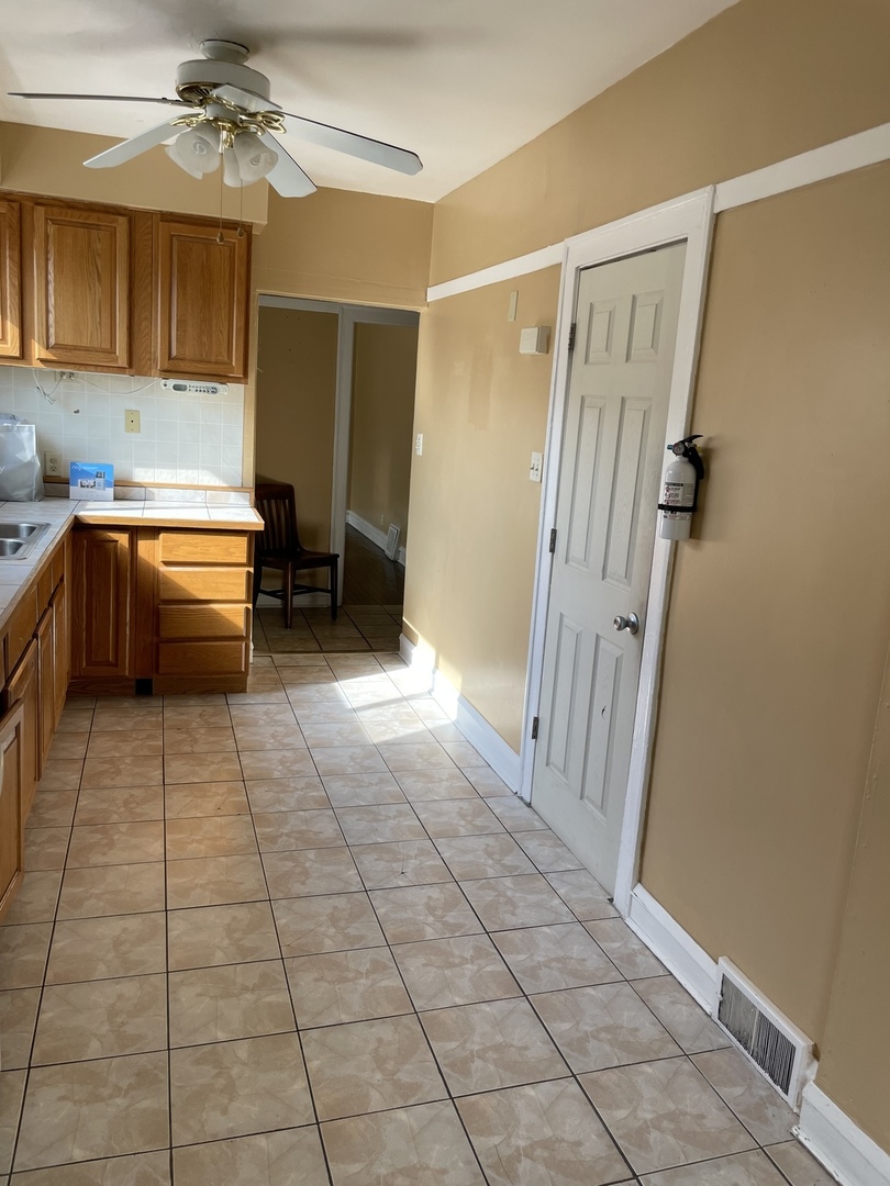 9309 South Ada Street Chicago, IL 60620 - Photo 15 of 39 a bathroom with a tub shower and a sink