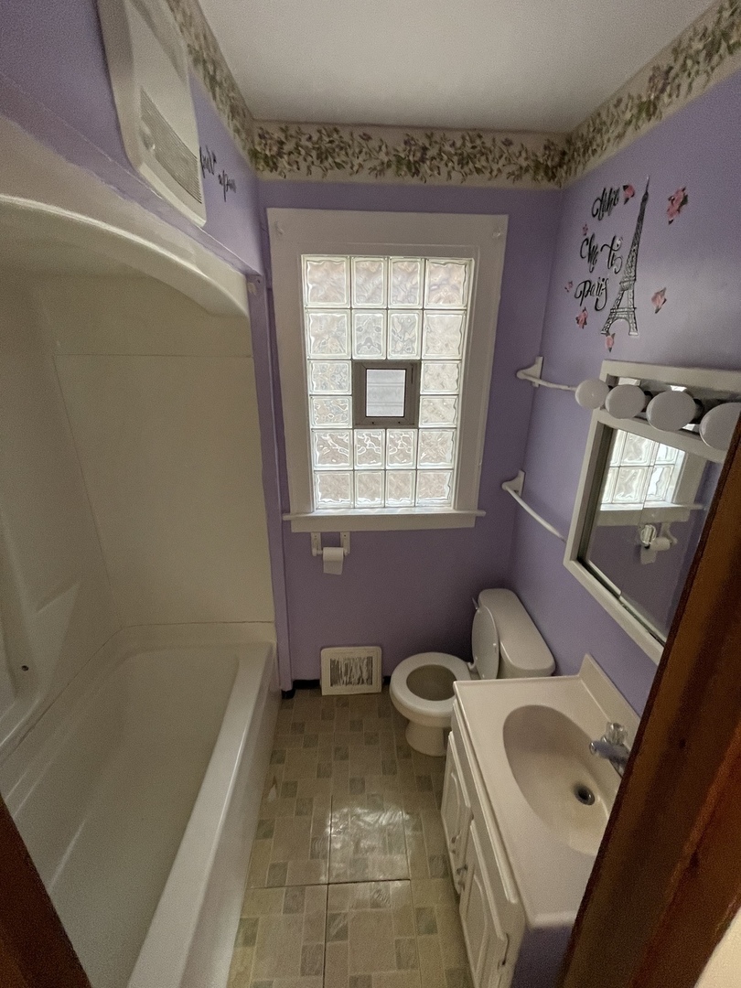 9309 South Ada Street Chicago, IL 60620 - Photo 23 of 39 a bathroom with a sink toilet and window