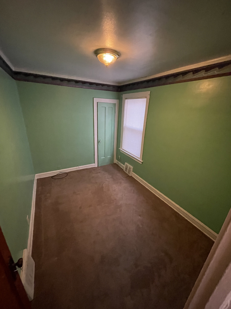 9309 South Ada Street Chicago, IL 60620 - Photo 24 of 39 a view of empty room with window