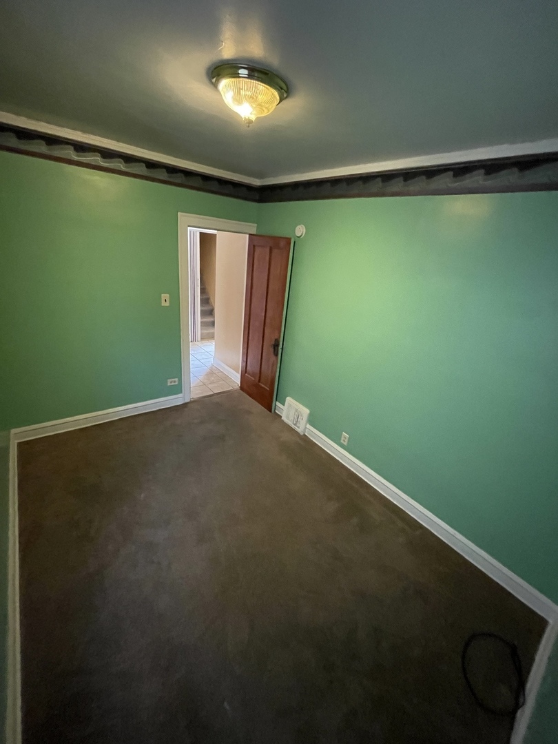 9309 South Ada Street Chicago, IL 60620 - Photo 27 of 39 a view of empty room with floor to ceiling window