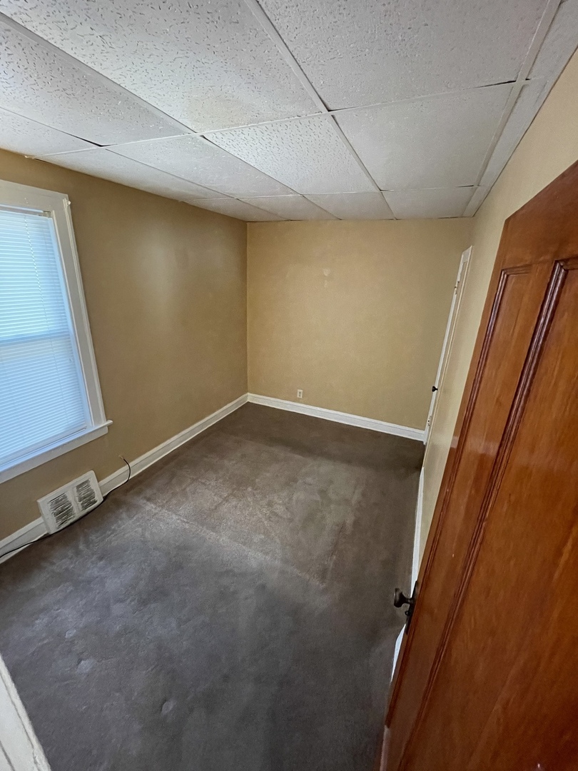 9309 South Ada Street Chicago, IL 60620 - Photo 28 of 39 a view of a room with wooden floor