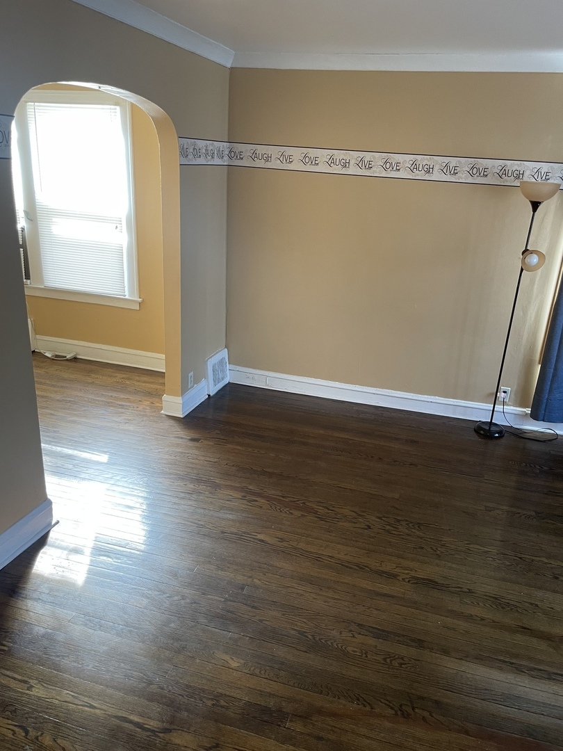 9309 South Ada Street Chicago, IL 60620 - Photo 3 of 39 a view of a room with wooden floor and a window