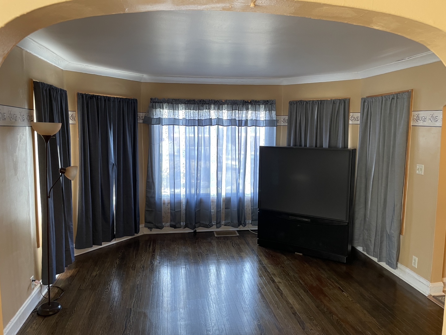 9309 South Ada Street Chicago, IL 60620 - Photo 6 of 39 an empty room with wooden floor and windows