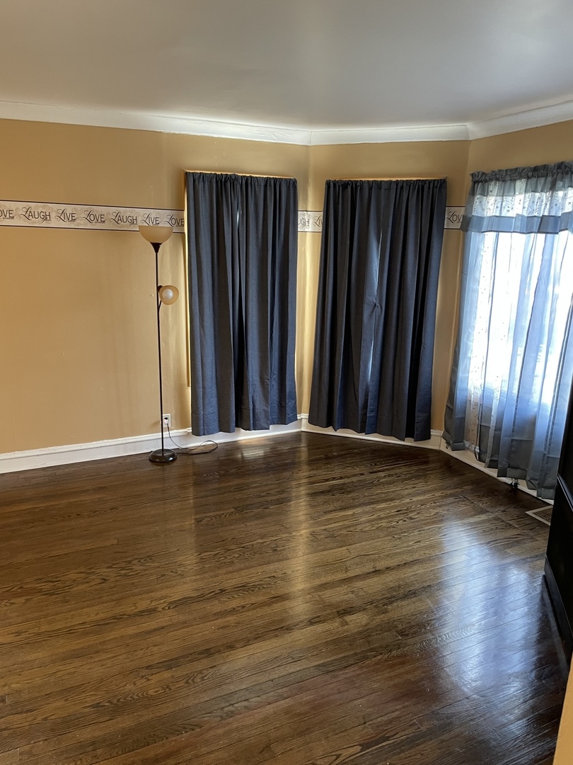 9309 South Ada Street Chicago, IL 60620 - Photo 7 of 39 a view of a room with wooden floor and windows