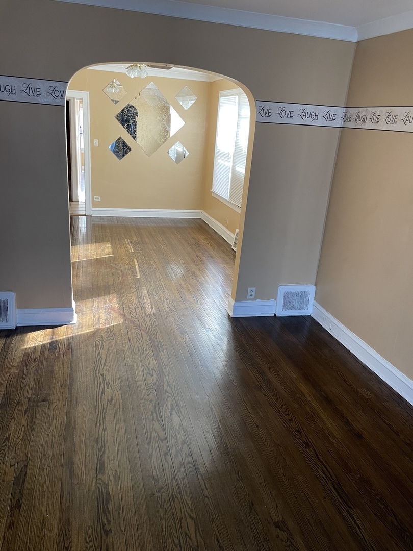 9309 South Ada Street Chicago, IL 60620 - Photo 10 of 39 a view of a big room with wooden floor and windows