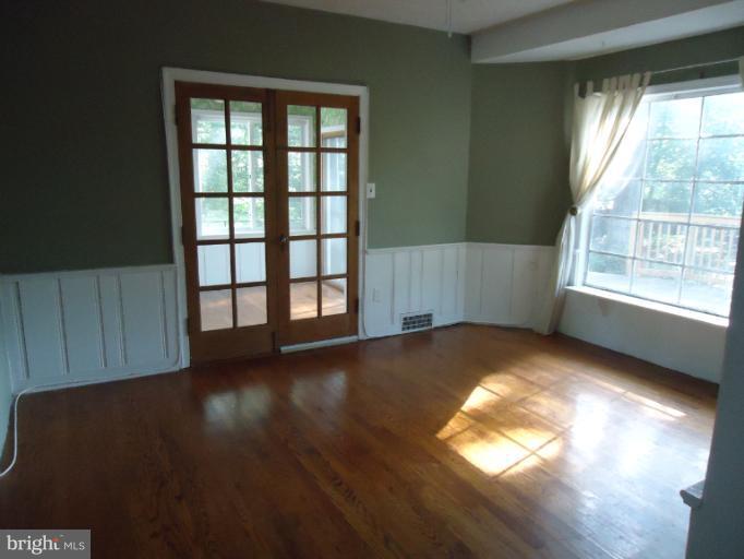 10407 Rodney Road Silver Spring, MD 20903 - Photo 3 of 9 wooden floor in an empty room with a window
