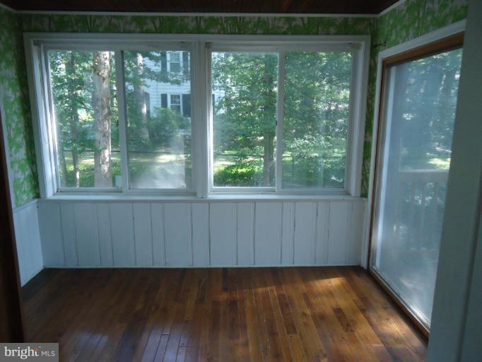 10407 Rodney Road Silver Spring, MD 20903 - Photo 6 of 9 a view of a room with wooden floor and large window