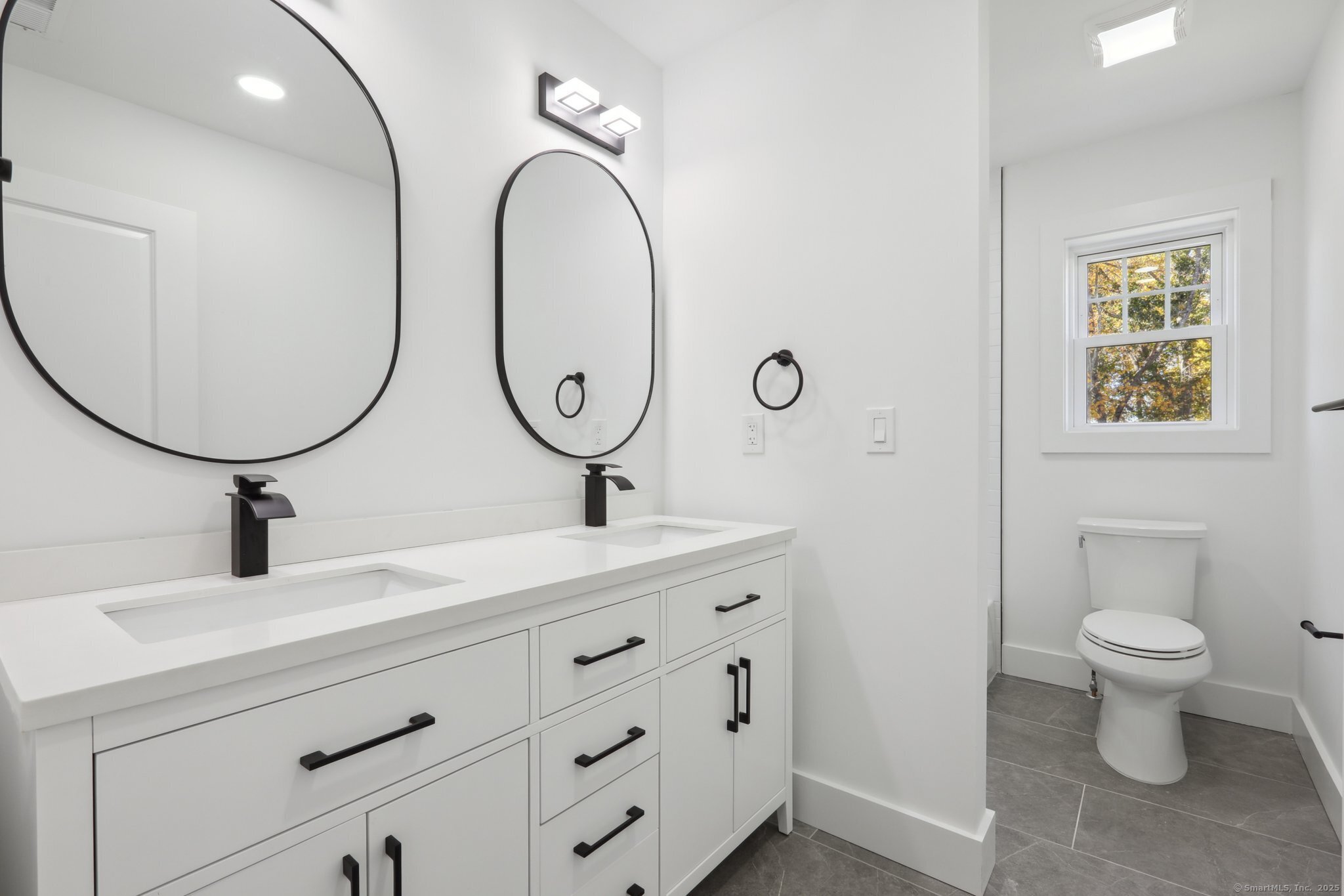 19 A Apache Drive Brookfield, CT 06804 - Photo 12 of 28 a bathroom with a toilet and a mirror