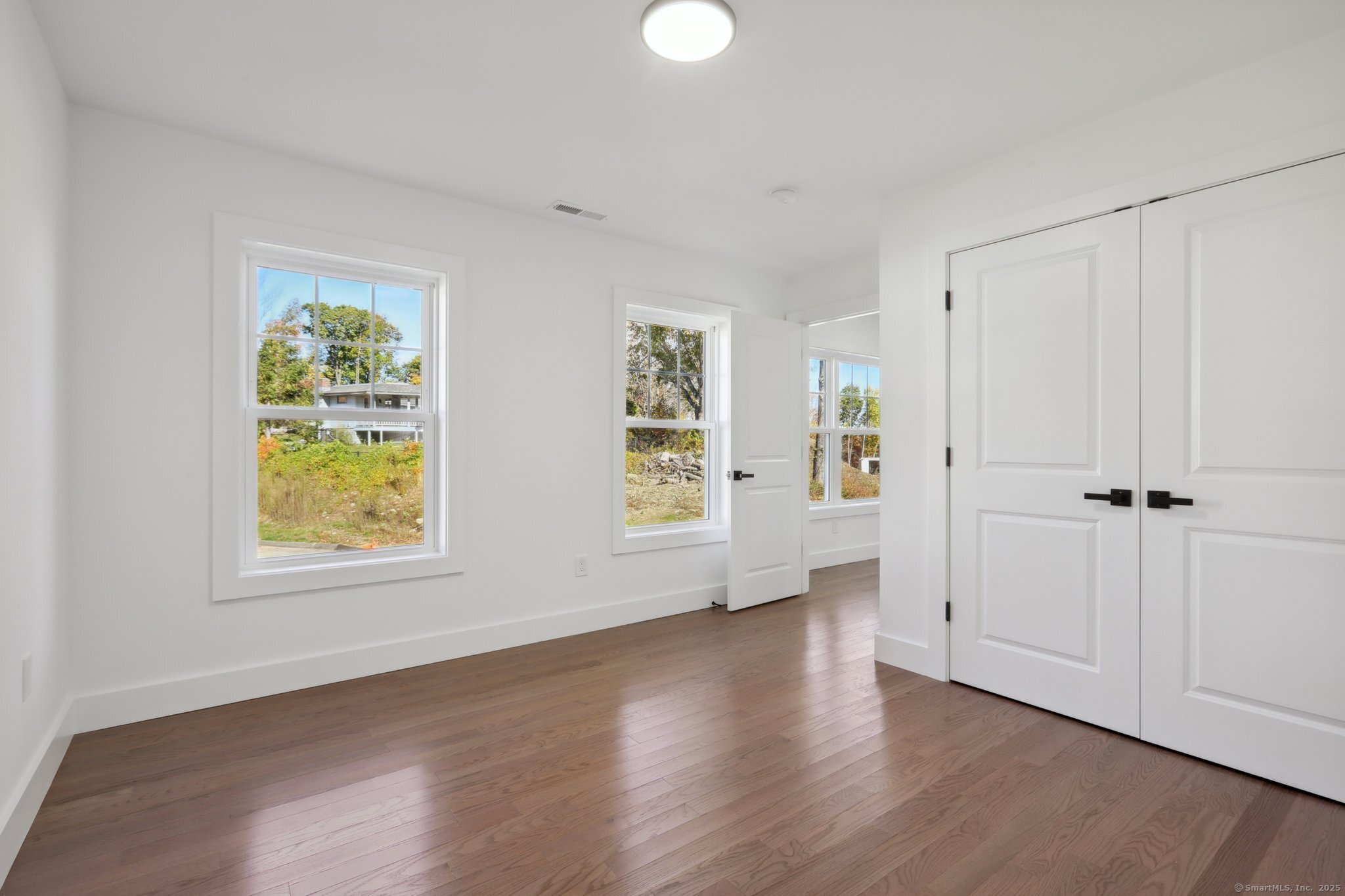 19 A Apache Drive Brookfield, CT 06804 - Photo 13 of 28 an empty room with wooden floor and windows