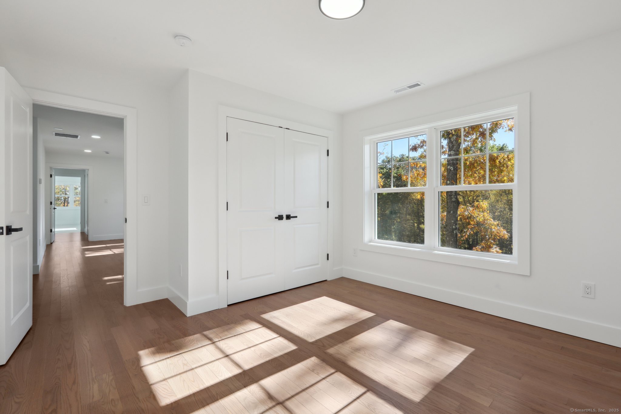 19 A Apache Drive Brookfield, CT 06804 - Photo 16 of 28 an empty room with wooden floor and windows