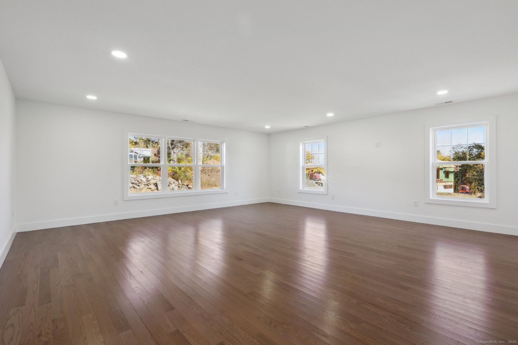 19 A Apache Drive Brookfield, CT 06804 - Photo 20 of 28 a view of an empty room with wooden floor and a window