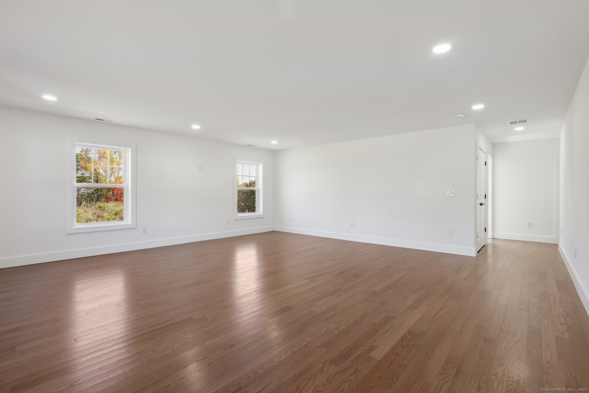 19 A Apache Drive Brookfield, CT 06804 - Photo 21 of 28 a view of an empty room with wooden floor and a window