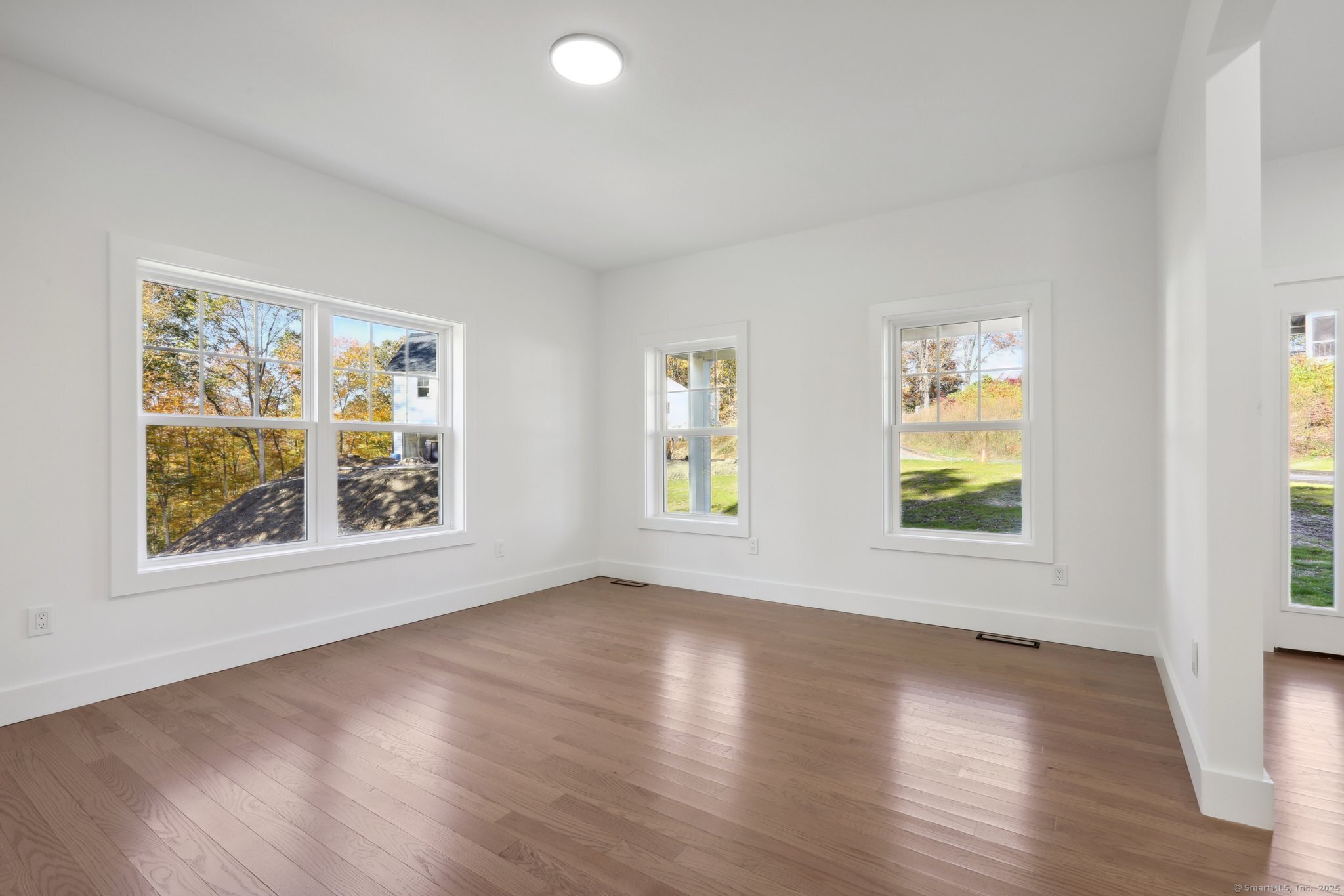 19 A Apache Drive Brookfield, CT 06804 - Photo 22 of 28 a view of an empty room with wooden floor and a window