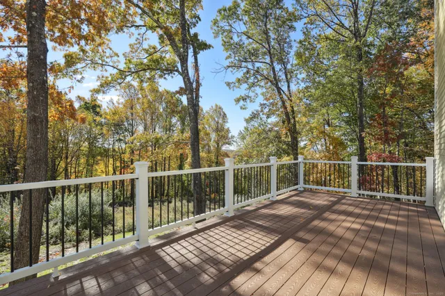 a view of a balcony with wooden floor and fence