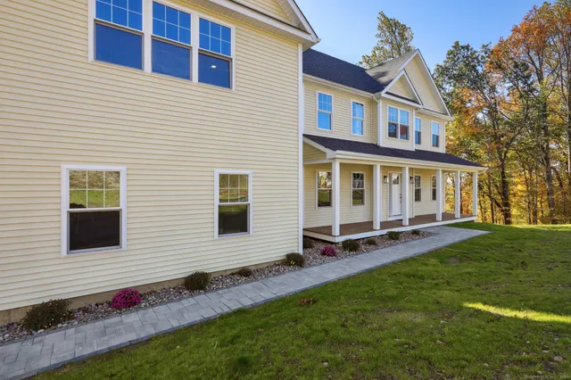a view of a house with backyard and sitting area