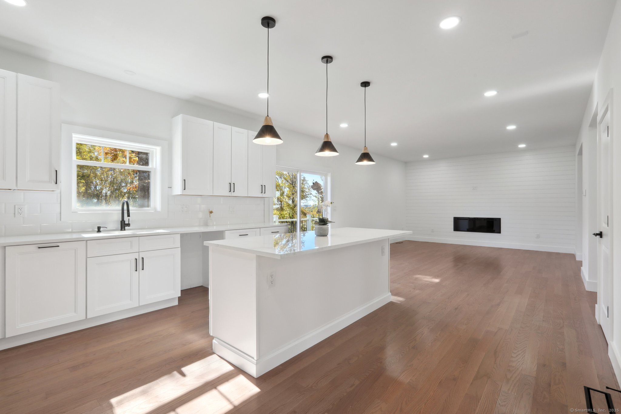 19 A Apache Drive Brookfield, CT 06804 - Photo 6 of 28 a large white kitchen with a white countertops a sink a window and stainless steel appliances