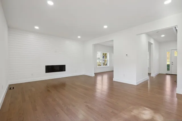 a view of an empty room with wooden floor