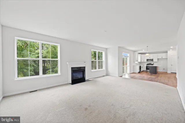 an empty room with a fireplace and a window
