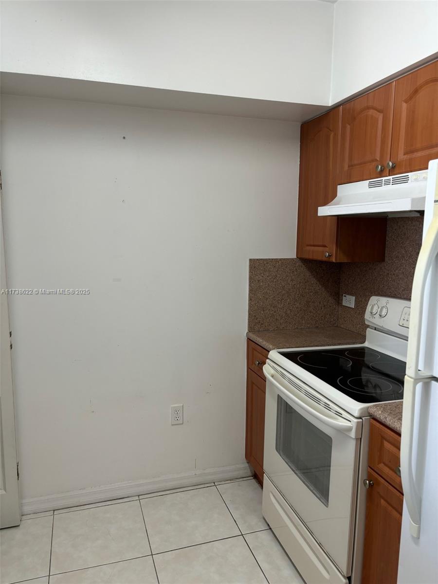West Flagler Miami, FL 33125 - Photo 5 of 11 a kitchen with a stove and a sink