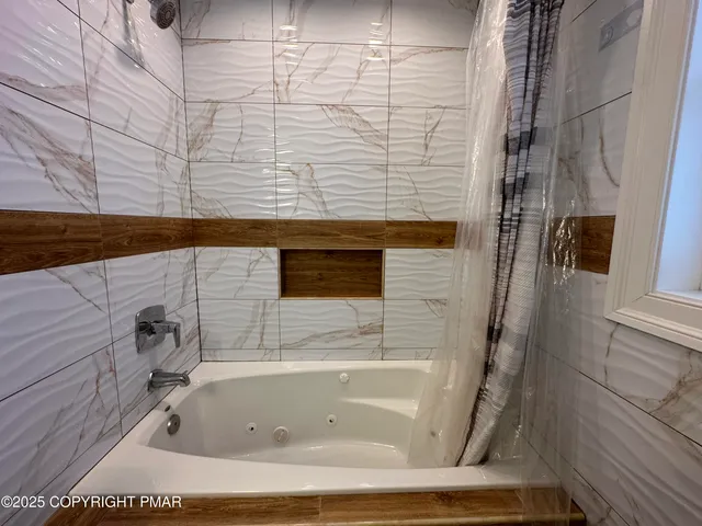 a backyard of a house with fire pit table and chairs