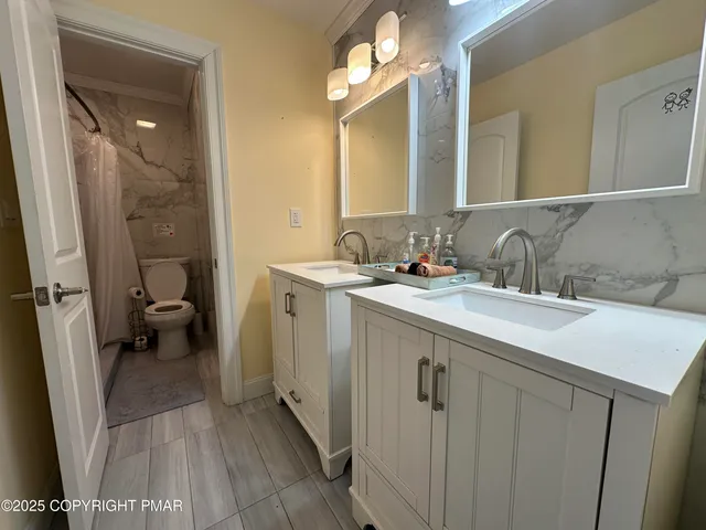 a view of a patio with table and chairs and wooden fence
