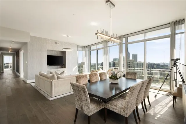 a dining room with furniture window and wooden floor