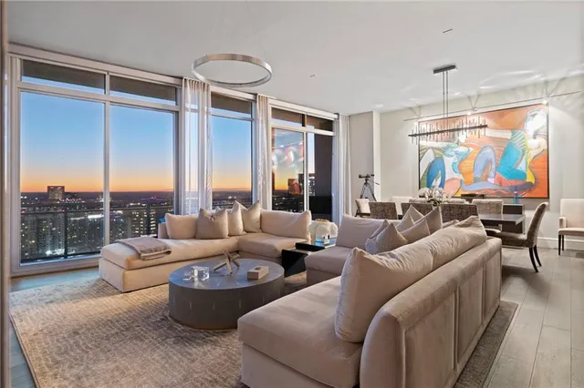 a living room with furniture a lamp and a potted plant