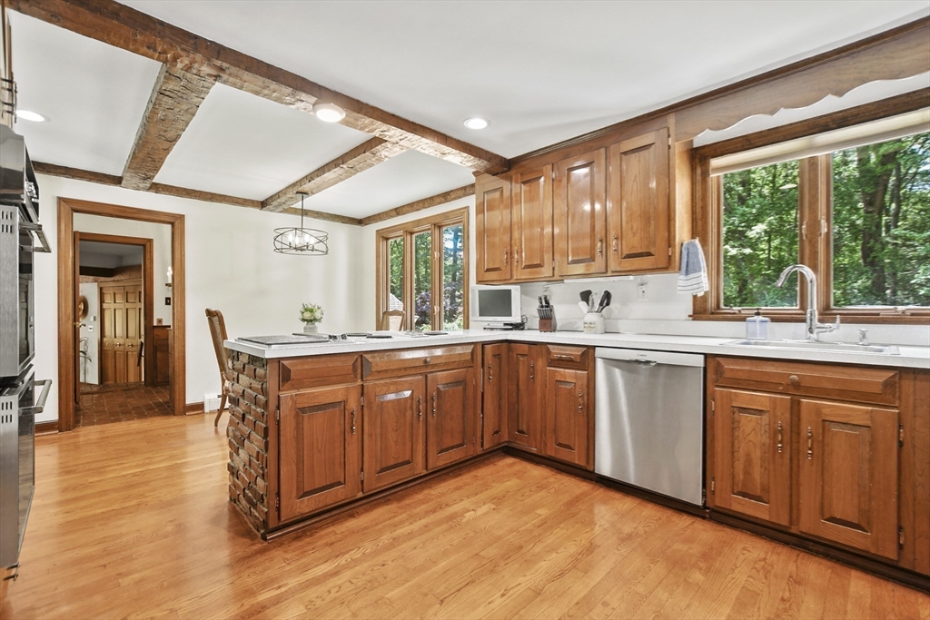 40 Herrick Road Boxford, MA 01921 - Photo 14 of 40 a kitchen with stainless steel appliances granite countertop a sink a stove cabinets counter space and a window